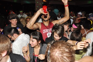 Ron Hudson, 19, sophomore of Detroit, takes a swig from his water bottle as multitudes of people dance around him at the Late Night at The Pit 80s Night Thursday. — Photo by Vera Ulitina Ron Hudson, 19, sophomore of Detroit, takes a swig from his water bottle as multitudes of people dance around him at the Late Night at The Pit 80s Night Thursday. — Photo by Vera Ulitina