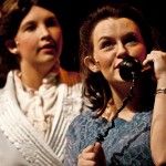 Amber Nightingale, junior of Morrill, speaks on the telephone to a male prospect while Jayma Loghry, freshman of Sidney, looks on during a dress rehearsal of “The Last Night of Ballyhoo” Monday. — Photo by T.J. Thomson