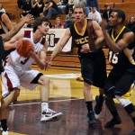 Eagle Kevin McClelland (3), junior guard of Long Beach, Calif., tries to shoot the ball while UCCS's guards of Colorado Springs, Colo., Ben Felimer (13), senior, and Alan Paul (15), sophomore, block him at the Men's Basketball game Saturday at the CSC Armstrong Gymnasium. — Photo by Vera Ulitina