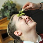 Cassie Munari, 20, junior of Cody, Wyo., reacts excitedly as Rayna Waggener, 19, sophomore of Alliance, applies an avocado mask to her face at Thursday’s RLA event “Beauty Secrets in Your Fridge." — Photo by Chelsie Moreland