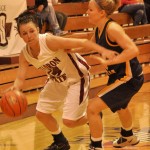 Eagle’s Kada Wiliams (14), junior guard of Green River, Wyo., drives down the sideline past Jodi Krall (12), senior guard of Solon, Iowa, during Saturday’s game against Colorado Christian University in Armstrong Gym. — Photo by Kinley Q. Nichols