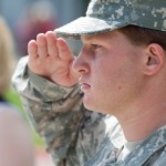 Tyler Trobee, 18, freshman of Johnston, Colo., salutes during the Sept. 11, 2001 memorial service on the Dean’s Green Monday morning — Photo by T.J. Thompson