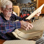 Don Holst, 81, of Chadron, leafs through the handwritten score of a symphony composed around the turn of the 20th century by his grandfather, Nels Marinus Holst. — Photo by Kevin Oleksy