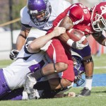 New Mexico Highlands' Call Barnard (42), sophomore of Melrose, N.M., pulls down Eagles' Quinell Atkins (26), junior of Fresno, Calif., during Saturday's game at Elliot Field.