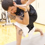 Christian McGhee, 21, senior point guard of Pine Ridge, S.D., stands in the Revolved Side Angle Sequence pose during a yoga class Oct. 6 in the NPAC. &mdash; Photo by Kinley Q. Nichols