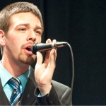 Jake Wirth, 20, sophomore of Sidney, sings a solo during the song “Not While I’m Around” during vocal jazz performance in Memorial Hall Tuesday. &mdash; Photo by Ashley Swanson