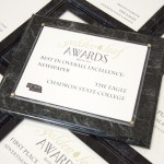 Several rows of awards, including The Eagle's "Best in Overall Excellence" honor, lie on a table Monday morning. The Eagle captured "Best in Overall Excellence" in 2013 for the third consectutive year.