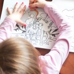 A child draws a spiral-shaped design. – Photo by Ashley Swanson